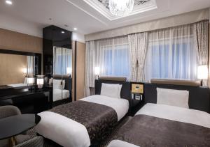 Postel nebo postele na pokoji v ubytování APA Hotel Ayase Ekimae