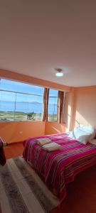 En eller flere senge i et værelse på SUMAQ WASI LLACHON casa de Juana