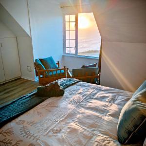 a bedroom with a bed with a view of the ocean at Swallow's Beach in Port Elizabeth