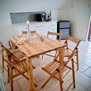 a wooden table with a candle on it in a kitchen at Swallow's Beach in Port Elizabeth