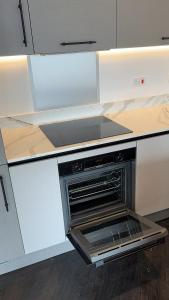 eine Küche mit offenem Backofen in einer Theke in der Unterkunft Luxury Ensuite Double bedroom in Poole