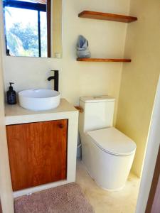 a bathroom with a toilet and a sink at Jungle surf Villa in El Zonte