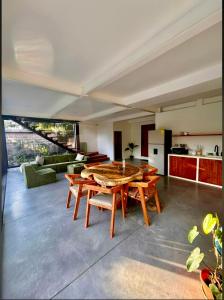 a large living room with a wooden table and chairs at Jungle surf Villa in El Zonte +3 photos