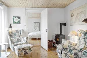 a living room with two chairs and a wood stove at 872-Bedsted-Thy-Lyngbyvej-25 in Bedsted Thy