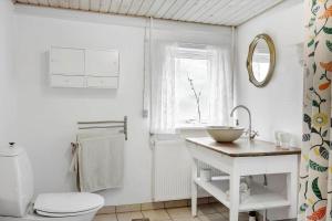 a bathroom with a sink and a toilet and a window at 872-Bedsted-Thy-Lyngbyvej-25 in Bedsted Thy +21 photos