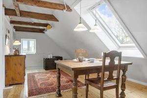 a dining room with a table and a chair at 872-Bedsted-Thy-Lyngbyvej-25 in Bedsted Thy