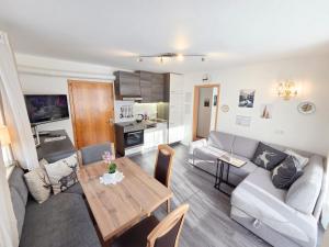 a living room with a couch and a table at am Mühlbach - Ferienwohnungen Luttinger in Bichlbach