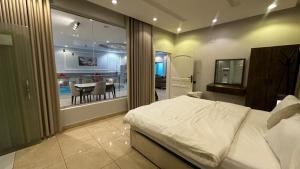 a bedroom with a large bed and a dining room at شاليه ايلان المدينة المنورة in Medina