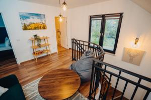 a living room with a table and a cat sitting on the floor at Cabana NorthSpot in Horodnic de Sus +33 photos