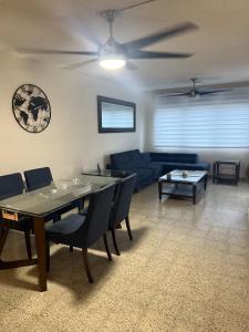 a living room with a table and a blue couch at Caguas Like Home in Caguas