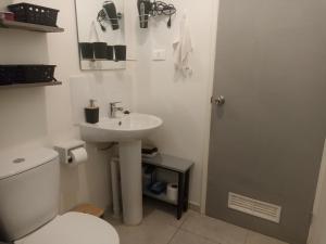 een witte badkamer met een wastafel en een toilet bij Casa en barrio tranquilo in Osorno +12 foto's