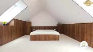 a bedroom with a bed and a skylight at Mezonet Jarková in Prešov +4 photos