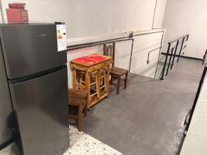 a kitchen with a refrigerator and a table and chairs at Departamento Loft Costanera in Gualeguaychú
