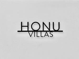 a sign that says home villas on a white wall at Honu Villas - Nui in Nosara