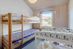 a bedroom with two bunk beds and a window at 546-Thisted-Kuttervej-16 in Thisted