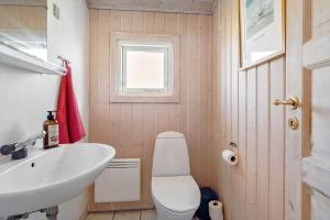 a bathroom with a white toilet and a sink at 546-Thisted-Kuttervej-16 in Thisted