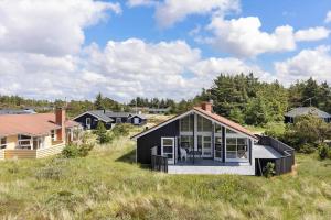 a black and white house in a field at 546-Thisted-Kuttervej-16 in Thisted