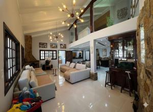 a large living room with couches and a bar at Pôr do Sol - Atibaia in Atibaia