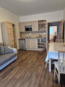 a living room with a kitchen and a dining table at Apartman Lúčky-Rea in Belá