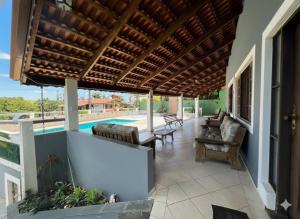 an outdoor patio with a wooden pergola and a pool at Pôr do Sol - Atibaia in Atibaia +17 photos
