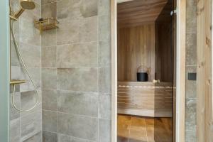 a bathroom with a shower with a glass door at 157-Thisted-Isfuglevej-17 in Thisted +23 photos