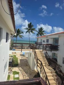 a view of the beach from the balcony of a house at Flat aconchegante em Itamaracá in Itamaracá