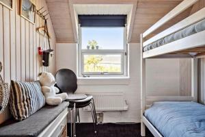 a small bedroom with a bunk bed and a chair at 332-Thisted-Kristinesvej-32 in Thisted