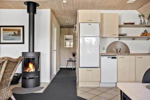 a kitchen with a stove with a fireplace in it at 332-Thisted-Kristinesvej-32 in Thisted +13 photos