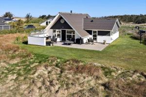a white house with a black roof in a field at 332-Thisted-Kristinesvej-32 in Thisted