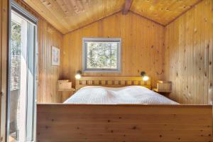 a bedroom with a bed in a wooden wall at 862-Thisted-Nordsovej-162 in Thisted