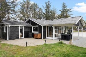 a black and white house with a patio at 862-Thisted-Nordsovej-162 in Thisted