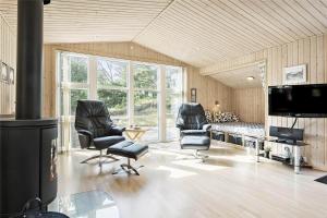 a living room with two chairs and a flat screen tv at 710-Thisted-Klitrosevej-10 in Thisted