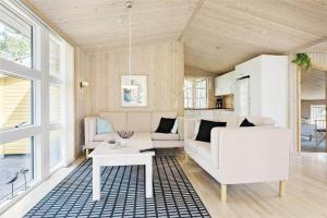 a living room with a couch and a table at 710-Thisted-Klitrosevej-10 in Thisted