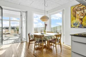 a kitchen and dining room with a table and chairs at 1053-Thisted-Kraenhavs-Sti-8 in Torsted