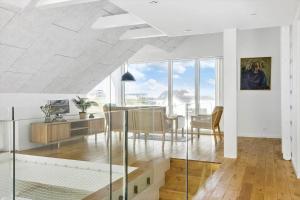 a living room with a table and a dining room at 1053-Thisted-Kraenhavs-Sti-8 in Torsted
