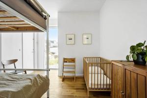 a bedroom with a bunk bed and a crib at 1053-Thisted-Kraenhavs-Sti-8 in Torsted