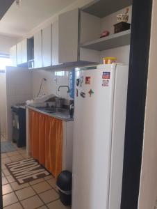a kitchen with a white refrigerator in a room at Apartamento BEIRA MAR - Edifício Mar Del Plata in Itamaracá +19 photos