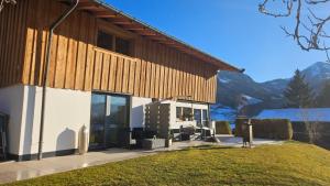 a building with glass doors on the side of it at Mountain Suite Brixen in Brixen im Thale