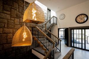 a staircase in a house with a clock on the wall at CASONA San Geronimo in Atotonilco el Alto +2 photos