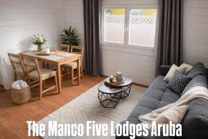 ein Wohnzimmer mit Sofa und Tisch in der Unterkunft Manco Five Lodges Aruba in Aruba
