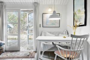 a white table and chairs in a room with a window at 1309-Thisted-Blabaervej-2 in Thisted