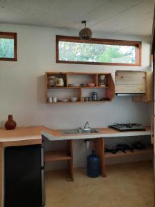 een keuken met een aanrecht, een wastafel en een raam bij Casa kuxtal in Zipolite