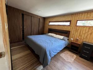 een slaapkamer met een bed met blauwe lakens en 2 ramen bij Domo Algarrobo 1 in San Antonio