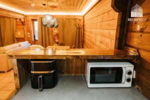 a microwave sitting on a counter in a room at Chalé Recanto 39 Luxury Mountain Retreat in Penhas da Saúde +16 photos