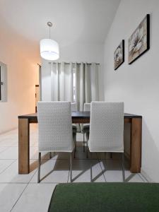 a dining room with a table and two chairs at Speranza in Il-Gżira