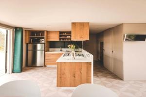 a kitchen with wooden cabinets and a counter top at 6-Guest Escape with Private Garden & Wi-Fi in Overbroek