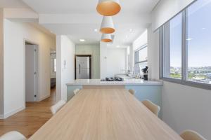 a large dining room with a long table and windows at Apto Reformado e Moderno com Vista Mar no Centro in Florianópolis +18 photos