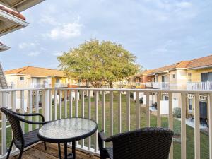 a patio with chairs and a table on a balcony at The Enchanted luxe Townhome in Kissimmee