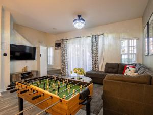 a living room with a foos ball on a table at The Enchanted luxe Townhome in Kissimmee