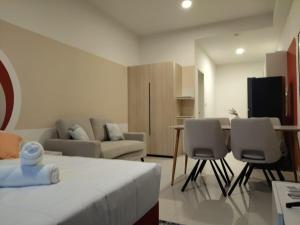 a room with a bed and chairs and a couch at Kampung Marsa at Majestic Residence, Kuala Lumpur in Kuala Lumpur +26 photos
